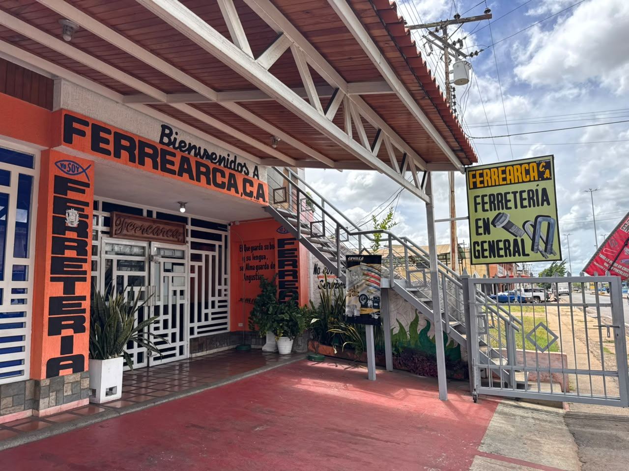 Ferrearca storefront with its orange facade and street sign